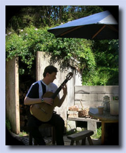 Photo of Bruce Paine playing guitar at Leigh Auckland