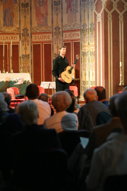 Photo of Bruce Paine playing classical guitar