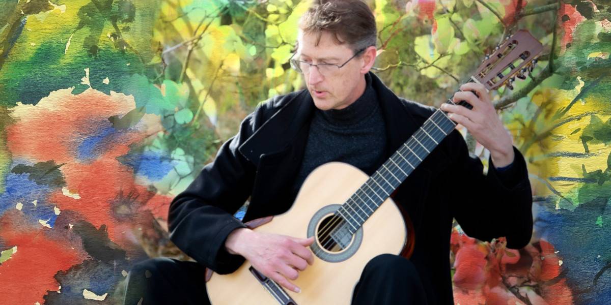 Bruce Paine guitarist with floral background